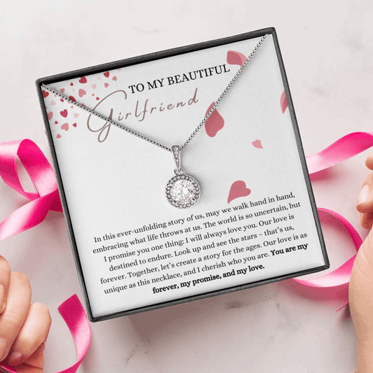 A person unwrapping a necklace gift, with a big cubic zirconia crystal pendant and a white gold finish, with a message card to my beautiful girlfriend..