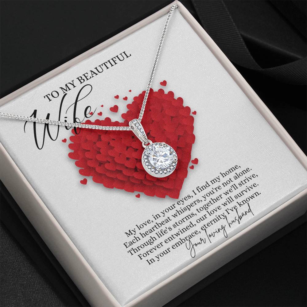 A necklace gift with a big cubic zirconia crystal pendant and a white gold finish, with a message card to my beautiful wife, in a Jewelry box.