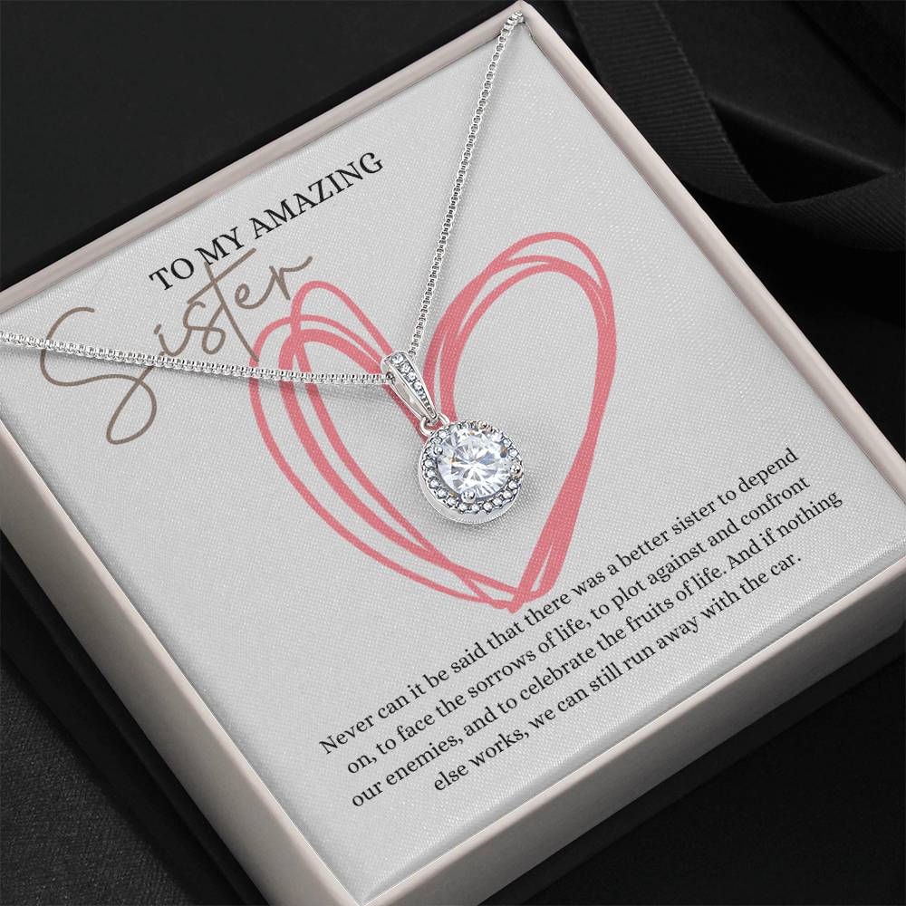 A necklace gift with a big cubic zirconia crystal pendant and a white gold finish, with a message card to my amazing sister, in a Jewelry box.