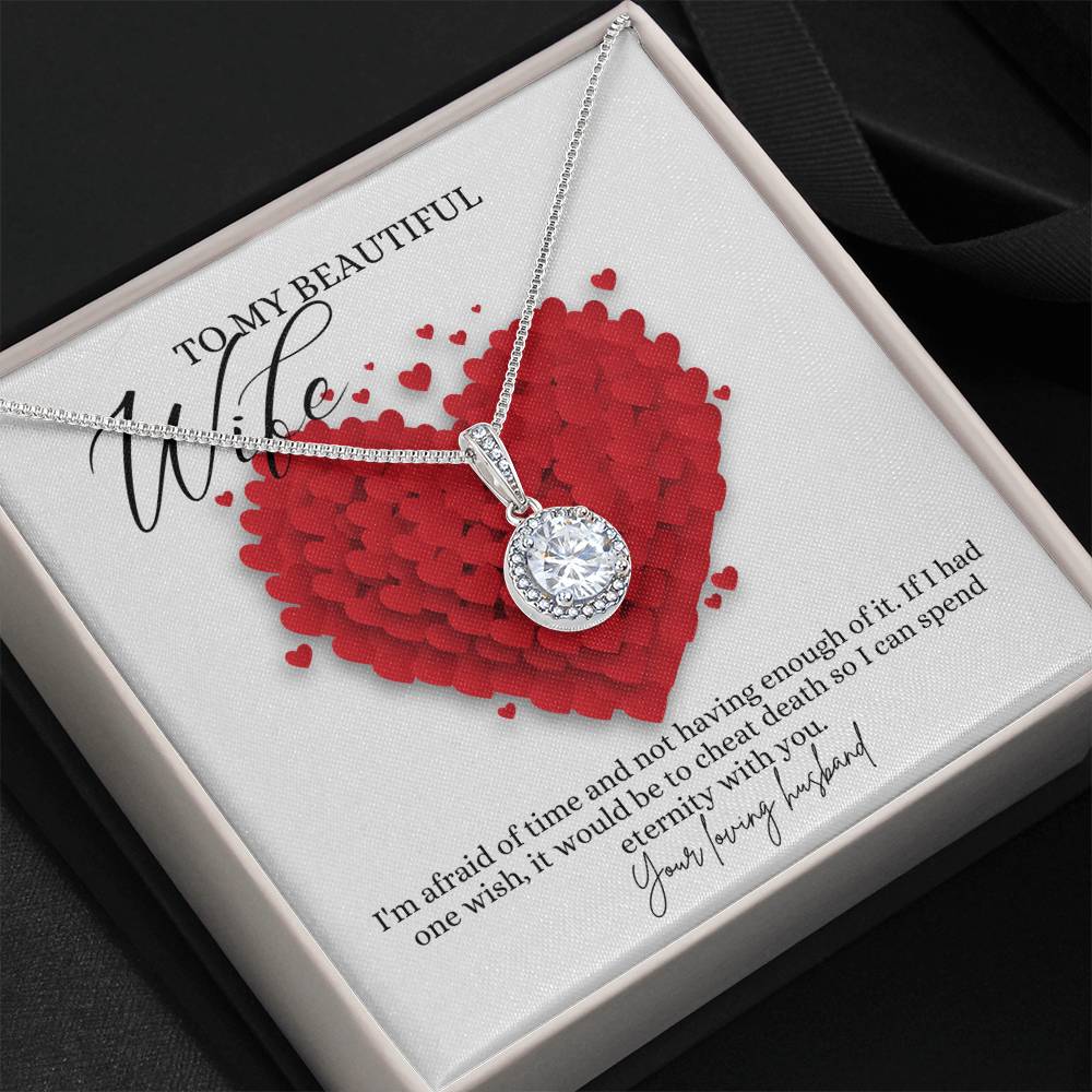 A necklace gift with a big cubic zirconia crystal pendant and a white gold finish, with a message card to my beautiful wife, in a Jewelry box.