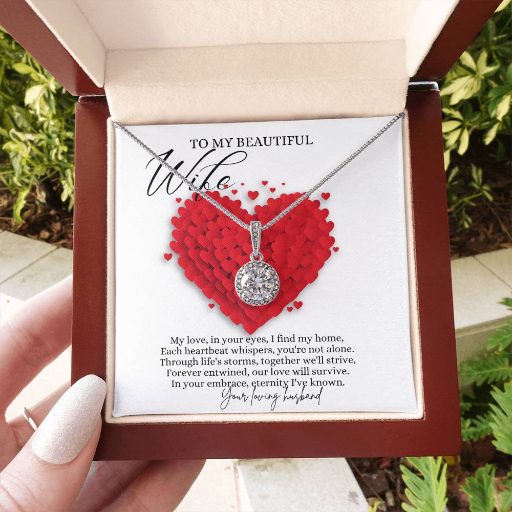 A woman holding a mahogany Jewelry box with a big cubic zirconia crystal pendant and a white gold finish, with a message card to my beautiful wife.