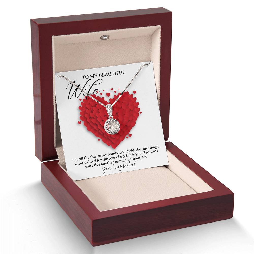 A necklace gift with a big cubic zirconia crystal pendant and a white gold finish, with a message card to my beautiful wife, in a mahogany Jewelry box. 