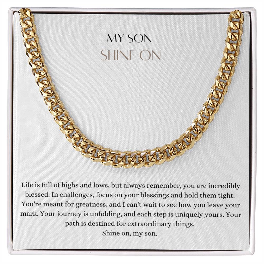 A Cuban chain necklace gift and a yellow gold finish, with a message card that says to my son, in a Jewelry box.