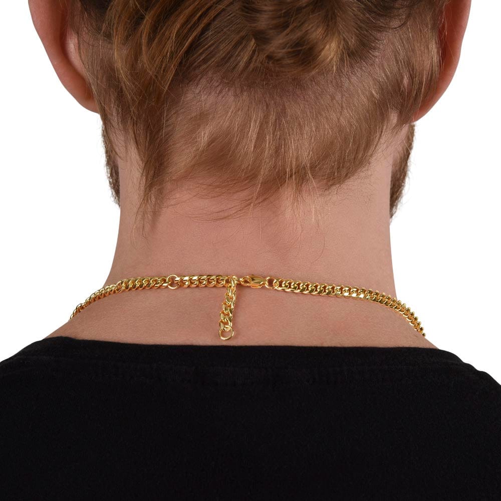 A man wearing a Cuban chain necklace with a yellow gold finish, showing the extension of the necklace from back.