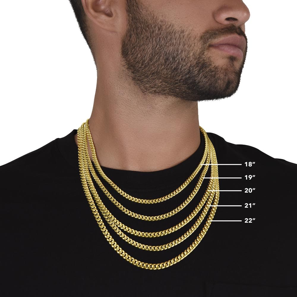 A man wearing multiple Cuban chain necklace with a yellow gold finish showing the possible length of the necklace.