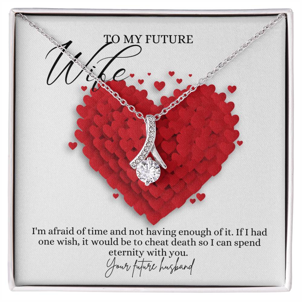 A necklace gift with ribbon shaped pendant with cubic zirconia crystals and a white gold finish, with a message card to my future wife in a Jewelry box.