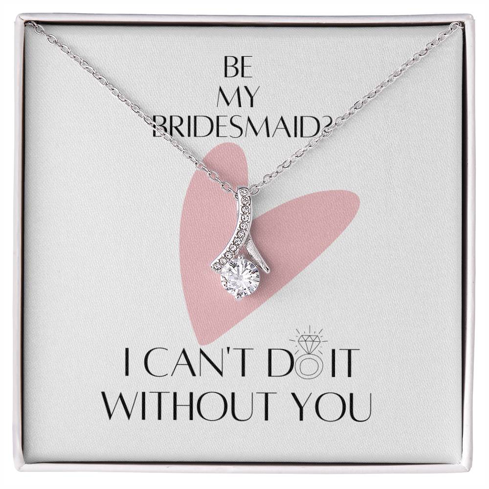 A necklace with ribbon shaped pendant made from cubic zirconia crystals and white gold finish with a message card for bridesmaids in a  Jewelry gift box.
