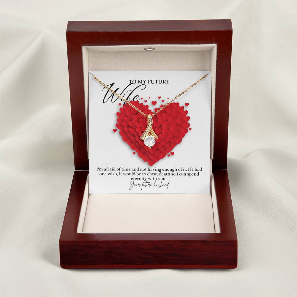 A necklace gift with ribbon shaped pendant with cubic zirconia crystals and a gold finish, with a message card to my future wife in a mahogany Jewelry box.