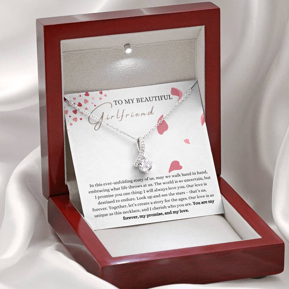 A necklace gift with ribbon shaped pendant with cubic zirconia crystals and white gold finish, with a message card to my beautiful girlfriend in a mahogany Jewelry box.