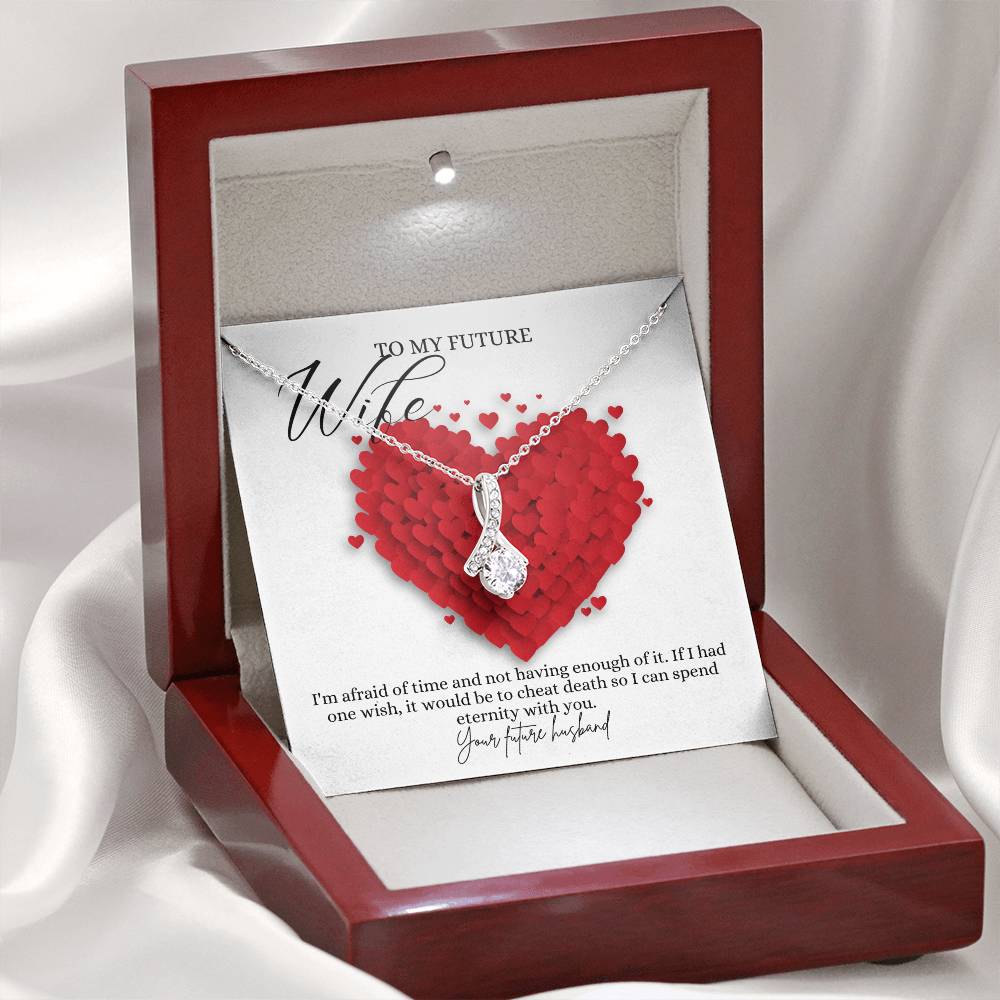A necklace gift with ribbon shaped pendant with cubic zirconia crystals and white gold finish, with a message card to my future wife in a mahogany Jewelry box.