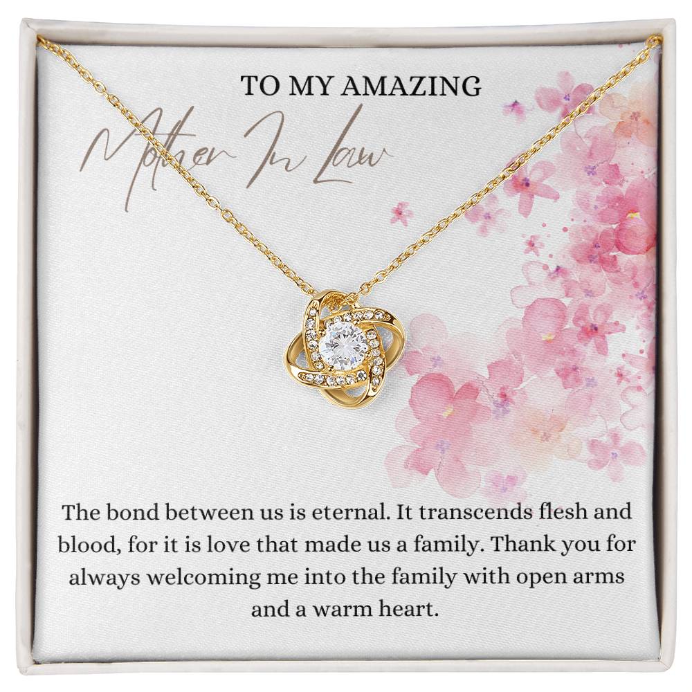 A yellow gold finish necklace gift, with a knot pendant embellished with premium cubic zirconia crystals, and a message card to my amazing mother-in-law, in a Jewelry box.