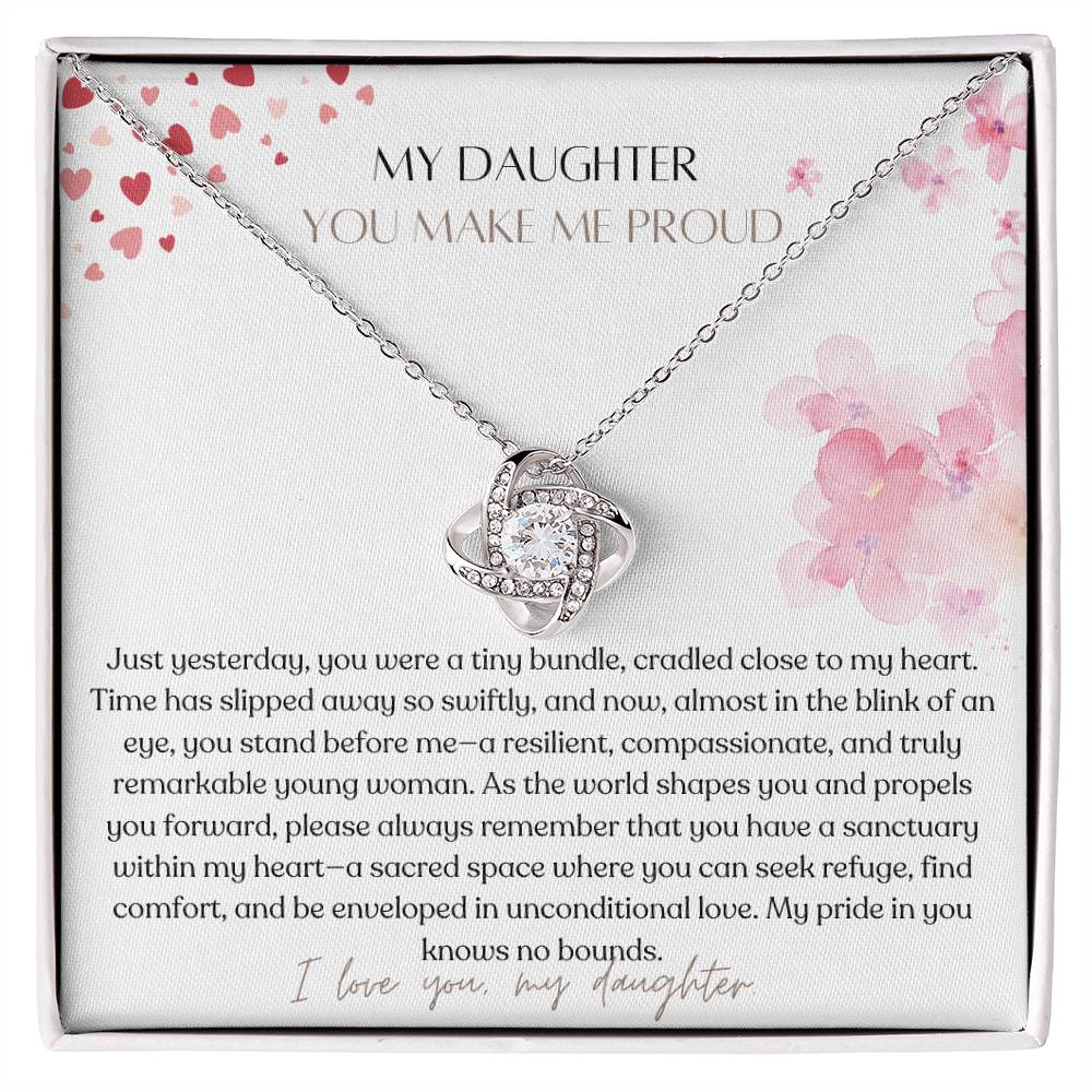 A Jewelry box, with a white gold finish necklace gift, with a knot pendant embellished with premium cubic zirconia crystals, and a message card to my daughter.