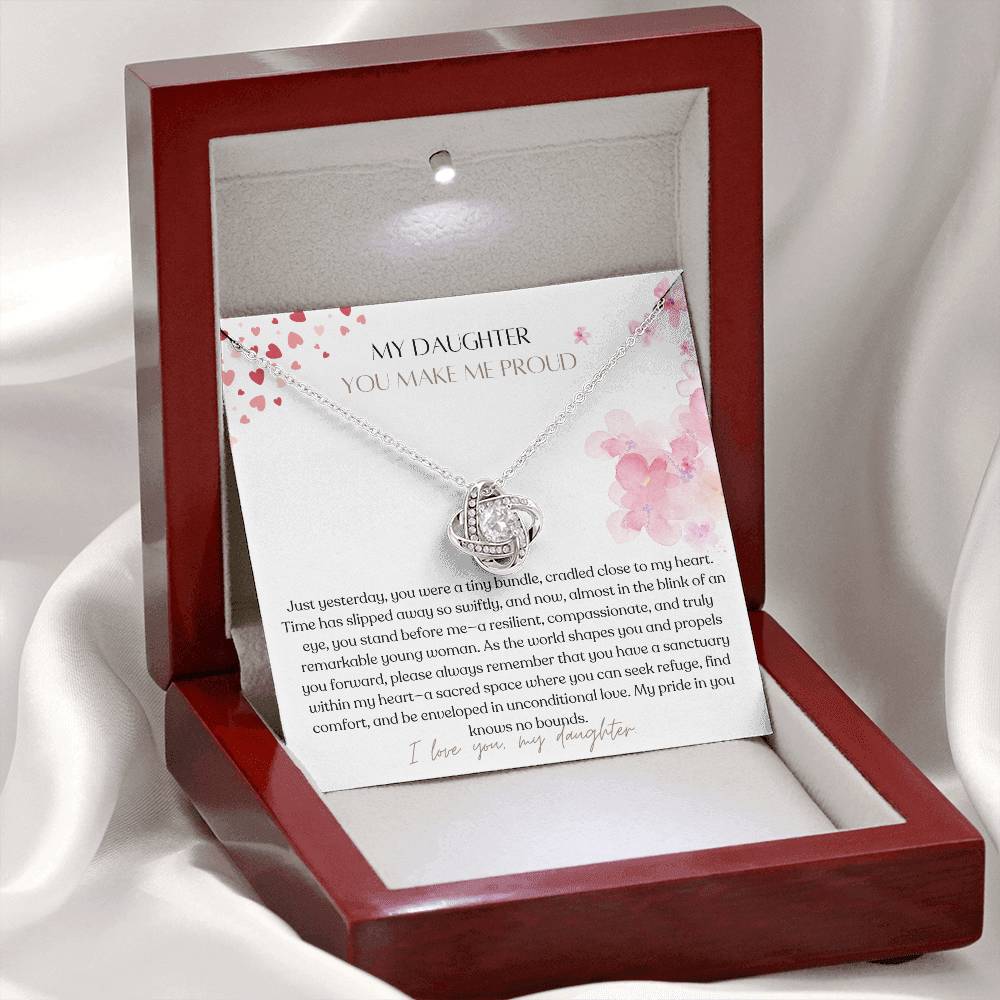 A white gold finish necklace gift, with a knot pendant embellished with premium cubic zirconia crystals, and a message card to my daughter, in a mahogany Jewelry box.