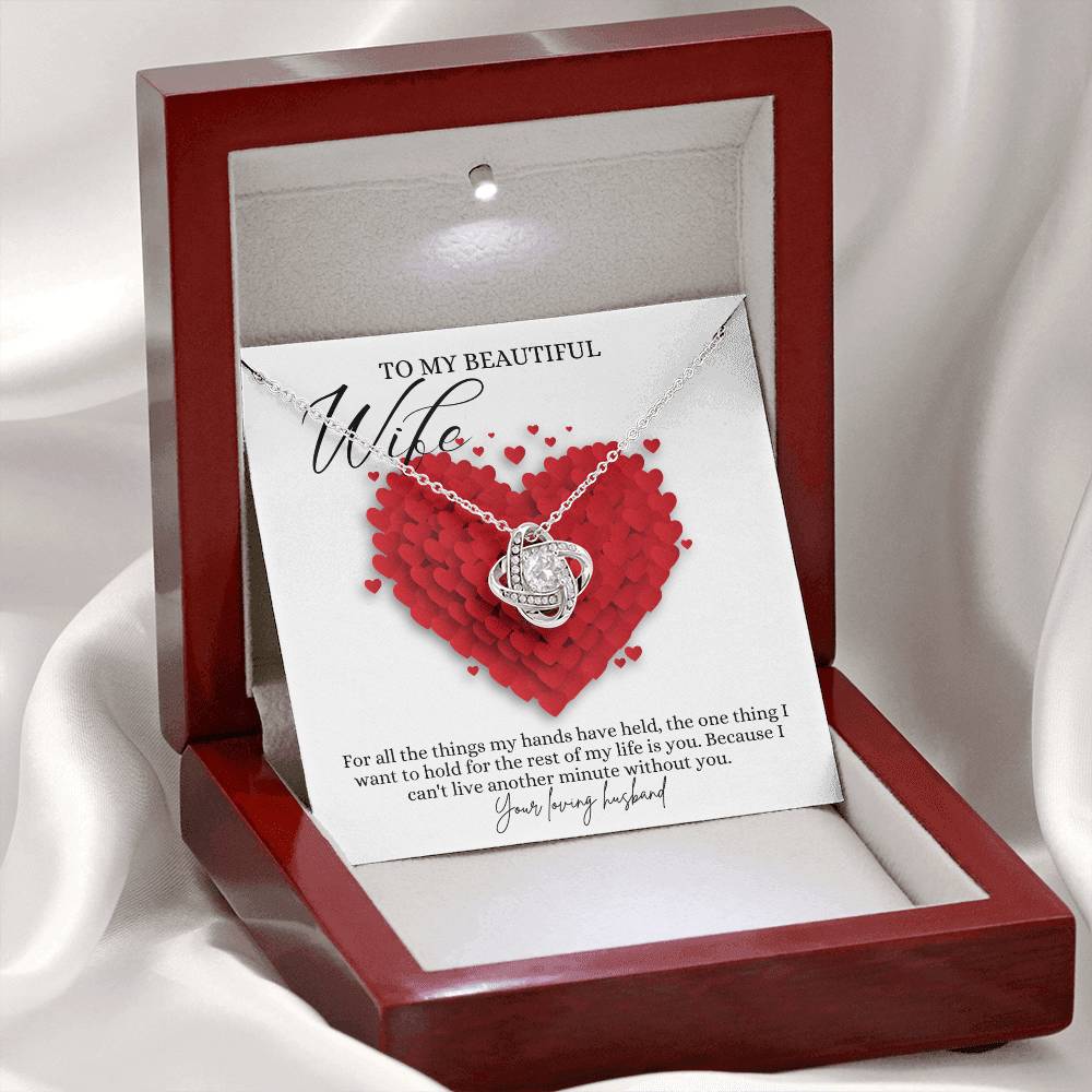 A white gold finish necklace gift, with a knot pendant embellished with premium cubic zirconia crystals, and a message card to my beautiful wife, in a mahogany Jewelry box. 