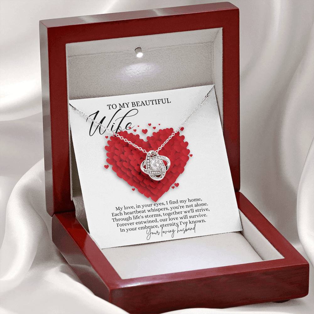 A white gold finish necklace gift, with a knot pendant embellished with premium cubic zirconia crystals, and a message card to my beautiful wife, in a mahogany Jewelry box. 
