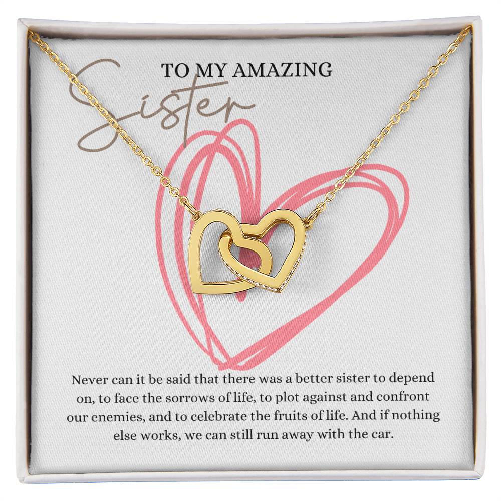 A necklace in a Jewelry gift box, with two connected hearts embellished with cubic zirconia crystals and a gold finish, with a message card to my amazing sister.