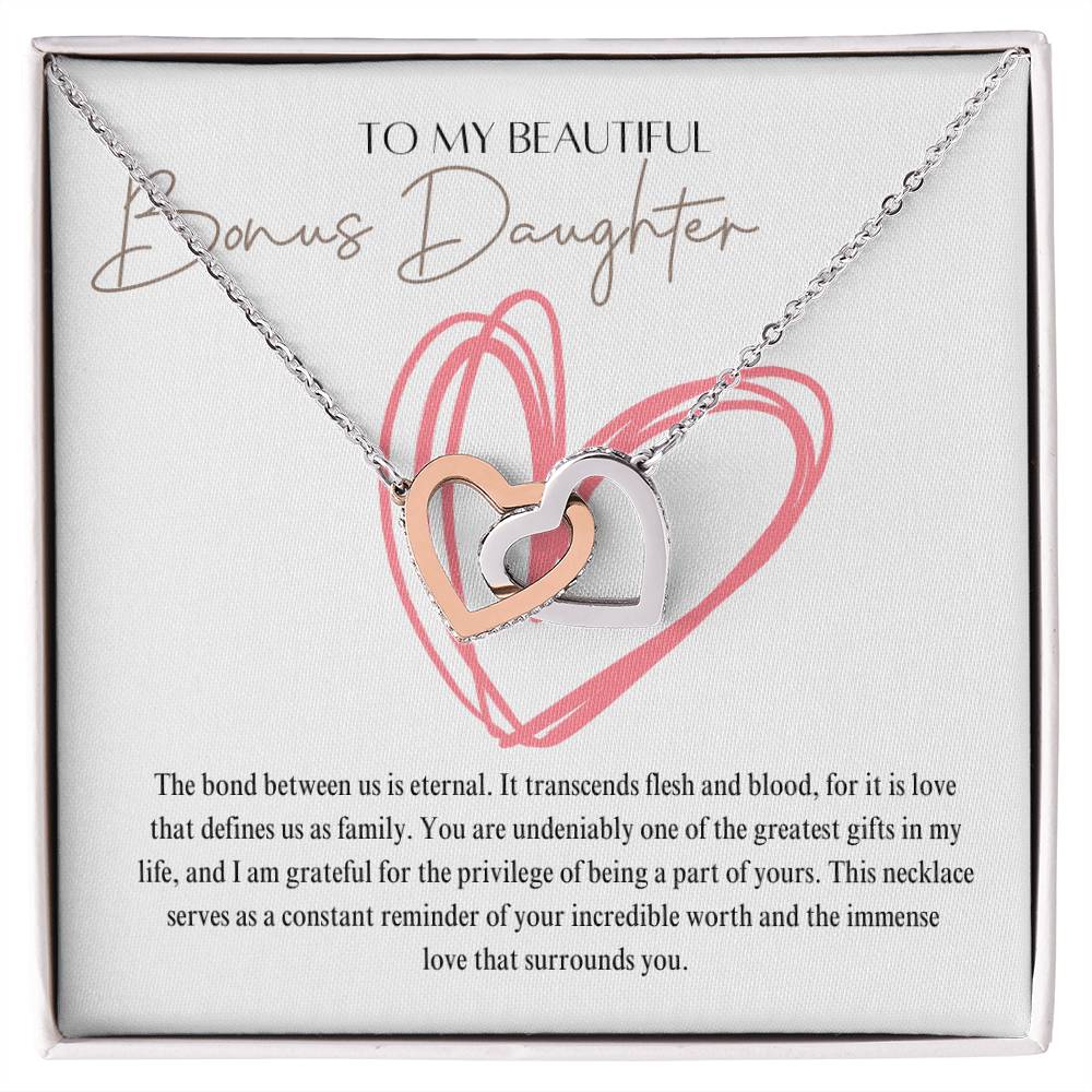 A necklace gift in a Jewelry box, with ribbon shaped pendant with cubic zirconia crystals and white gold finish, with a message card to my beautiful bonus daughter. 