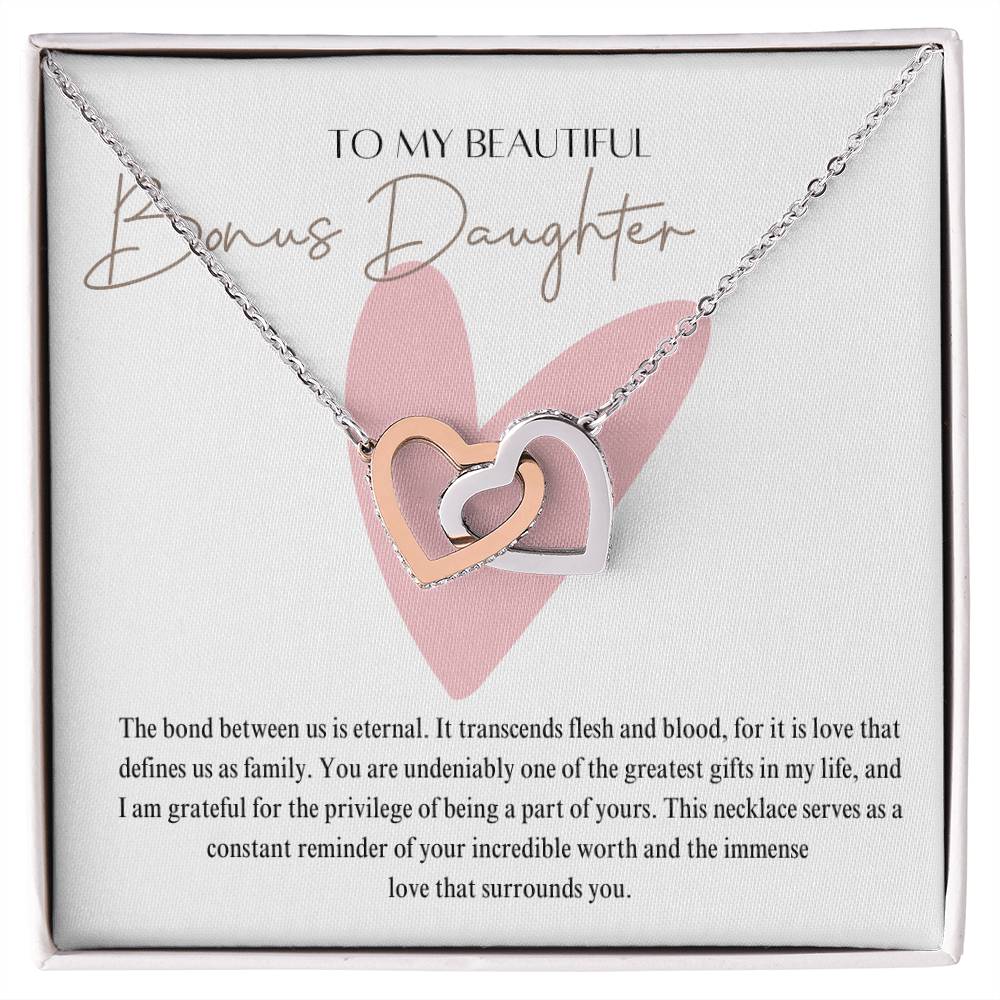 A necklace gift in a Jewelry box, with ribbon shaped pendant with cubic zirconia crystals and white gold finish, with a message card to my beautiful bonus daughter.