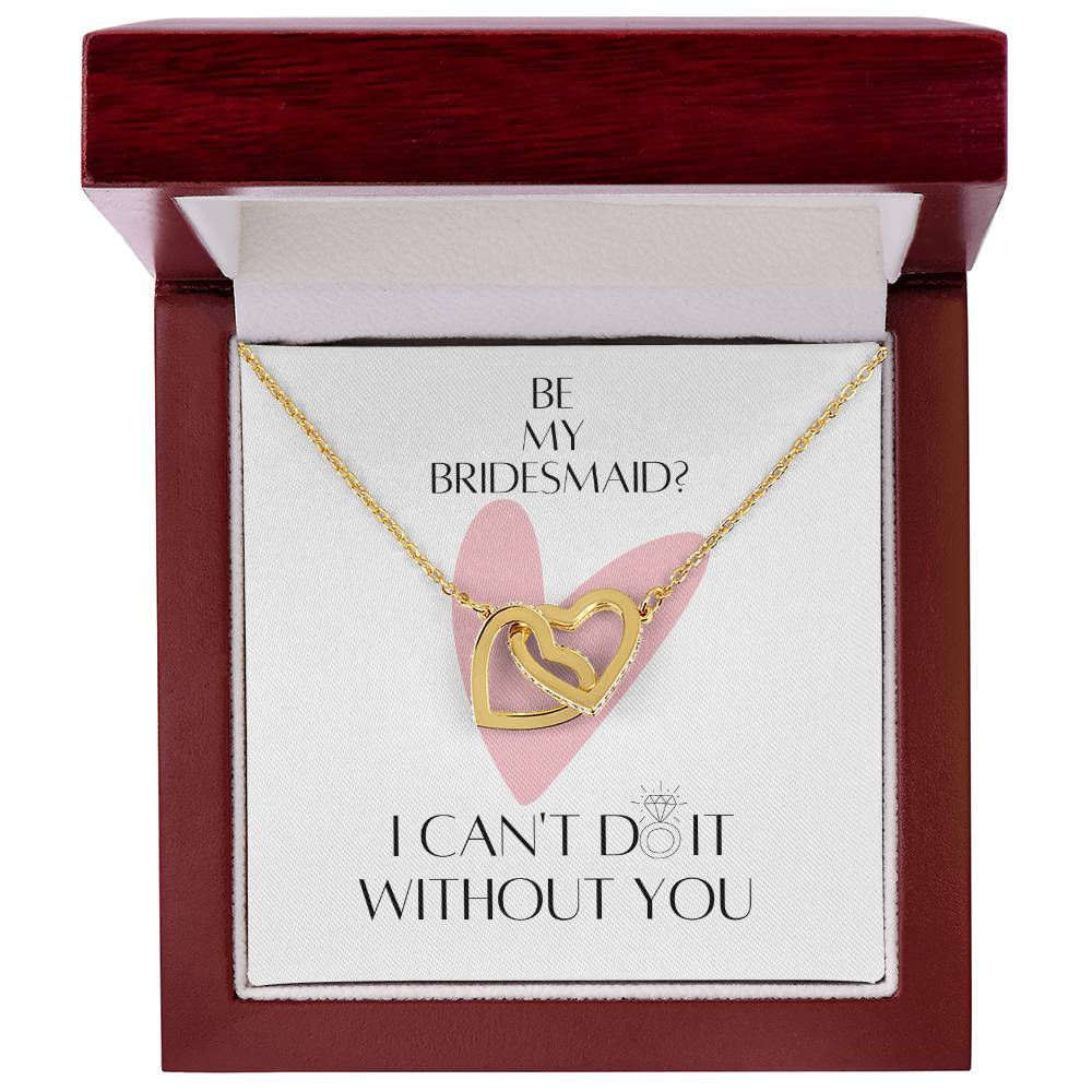 A mahogany Jewelry box with a necklace with two connected hearts embellished with cubic zirconia crystals and gold finish, and a message card for bridesmaids.