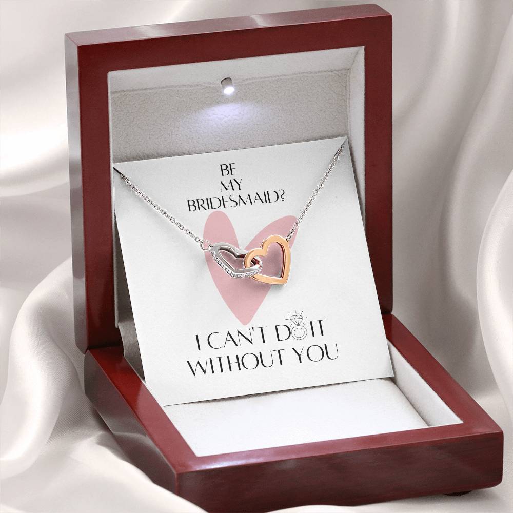 A mahogany Jewelry box with a necklace with two connected hearts embellished with cubic zirconia crystals and white gold finish, and a message card for bridesmaids.