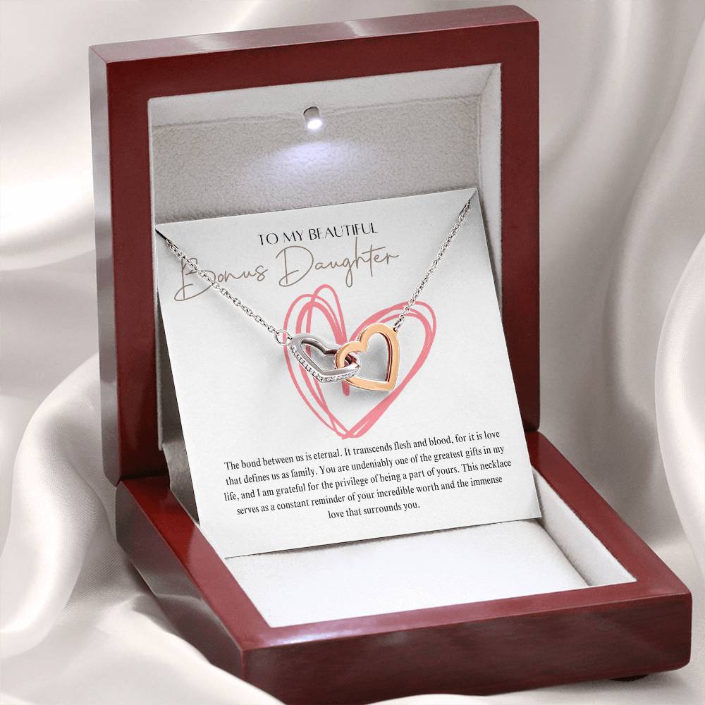 A mahogany Jewelry box, with a necklace with two connected hearts embellished with cubic zirconia crystals and white gold finish, with a message beautiful bonus daughter.