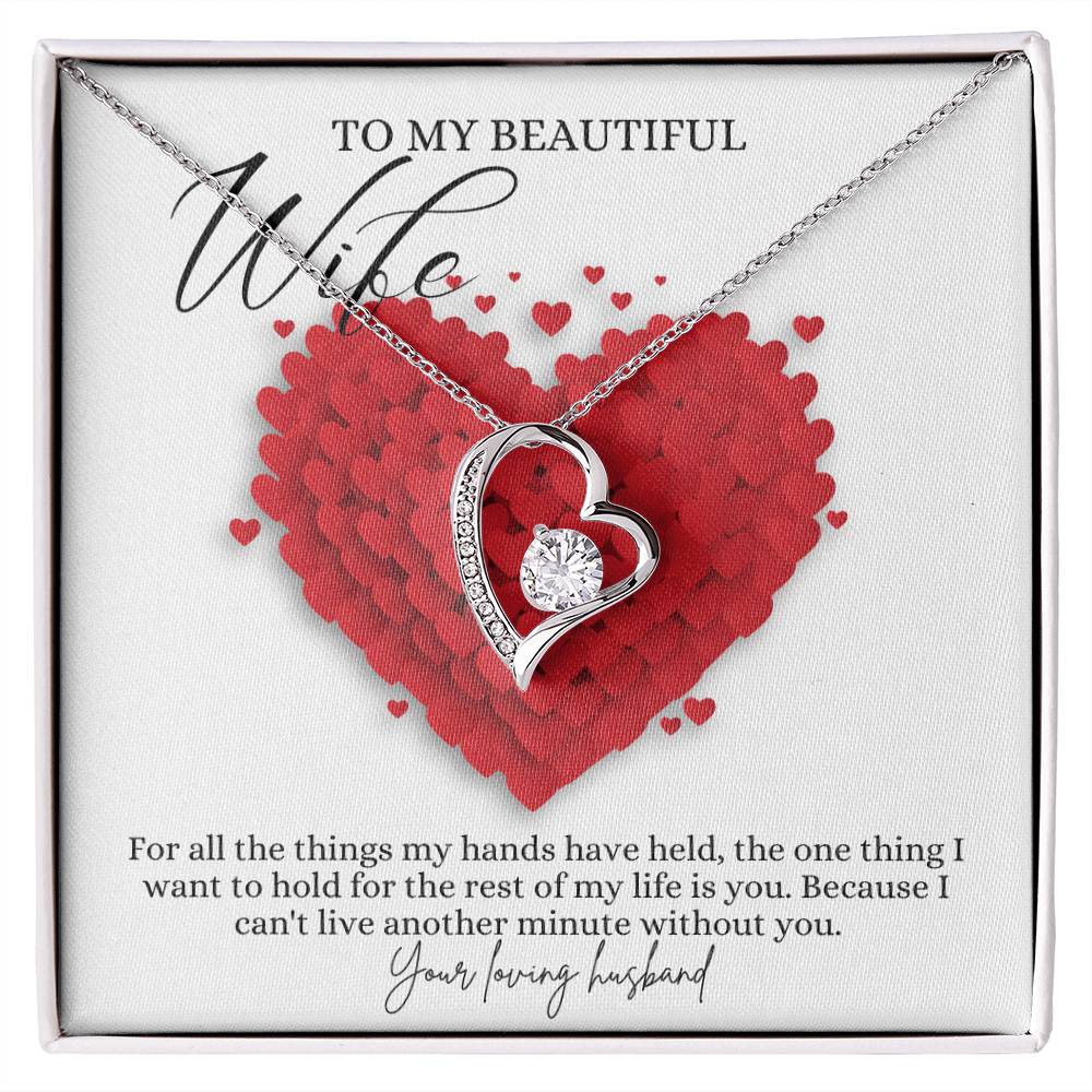 A white gold finish necklace gift, featuring a stunning 6.5mm CZ crystal surrounded by a polished heart pendant embellished with smaller crystals, with a message card to my beautiful wife, in a Jewelry box.