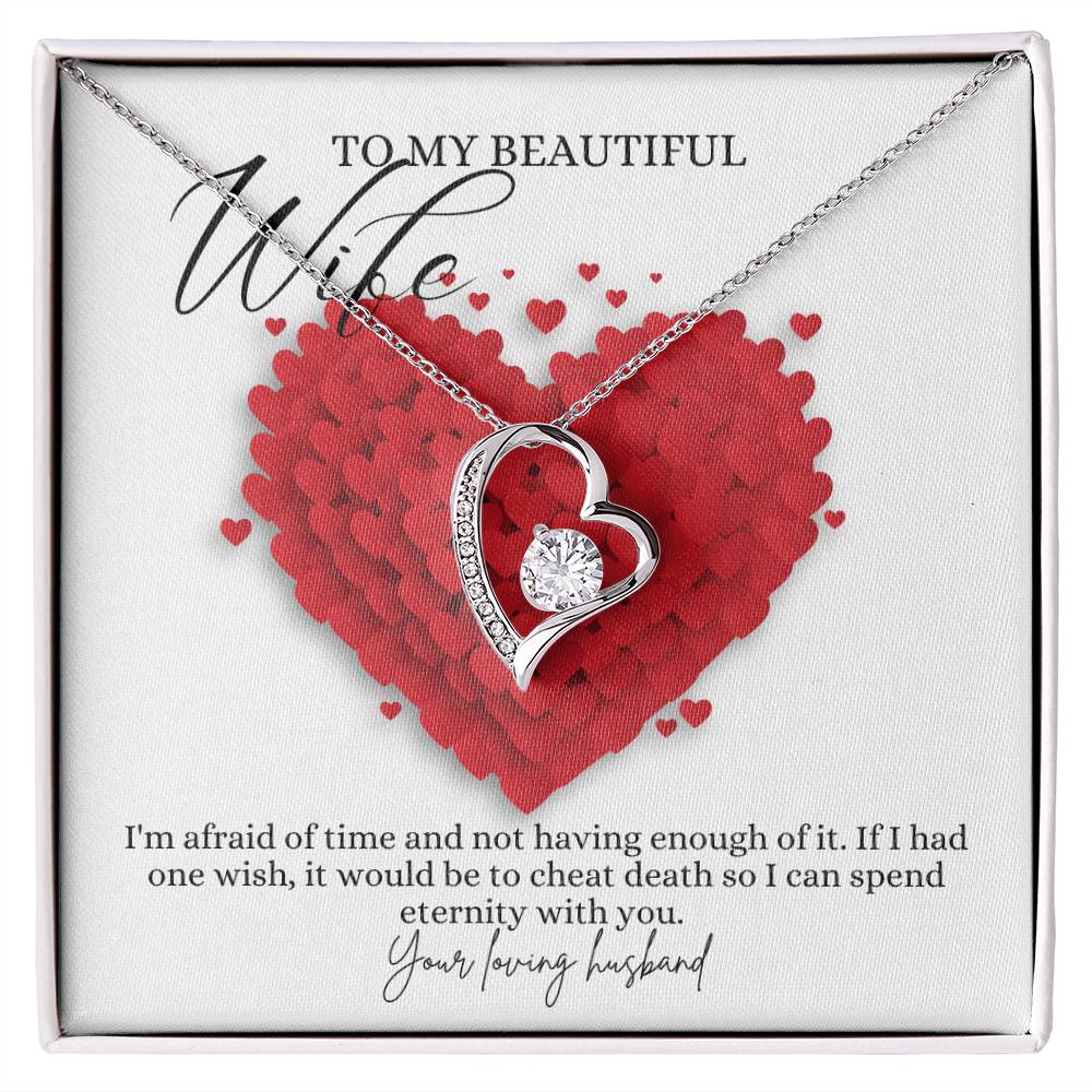 A white gold finish necklace gift, featuring a stunning 6.5mm CZ crystal surrounded by a polished heart pendant embellished with smaller crystals, with a message card to my beautiful wife, in a Jewelry box.